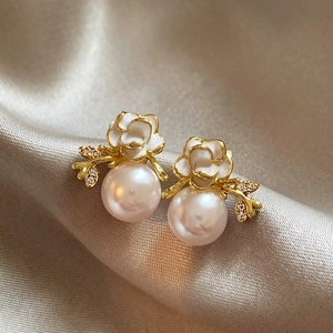 Detailed view of elegant 18k gold plated flower and pearl stud earrings for women