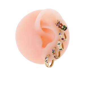 Gold earrings with multi-colored cubic zirconia stones shown on a silicone ear model
