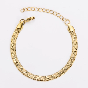 Close-up of golden flat snake bone chain with textured weave and adjustable extender