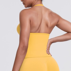 Back view of high-impact yellow halter neck sports bra and high-waist yoga leggings set
