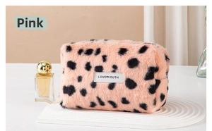 Pink leopard print plush cosmetic bag with Love Youth label on white display stand