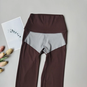 Detail view of high-waist yoga leggings in coffee and grey with reinforced stitching