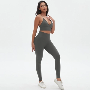 Detail of seamless dark gray ribbed sports bra and high-waisted yoga leggings set