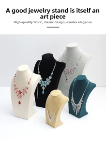 Detail view of multi-material jewelry bust stands with luxury gemstone necklaces