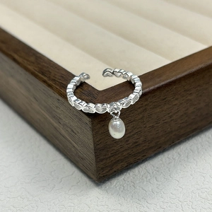 Elegant s925 silver open heart ring with freshwater pearl charm on a wooden display