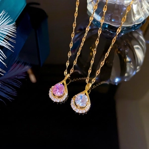 Two gold-plated waterdrop necklaces with sparkling crystal pendants and leaf-shaped links