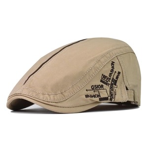 Detail of light khaki twill cotton ivy cap featuring black street fashion embroidery