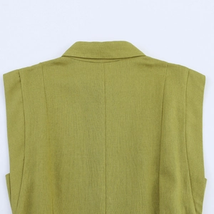 Macro view of olive green sleeveless dress showing textured fabric and back stitching