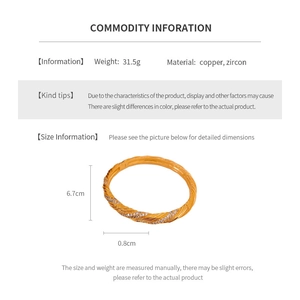 Detail view of 18k gold plated twisted bangle made of copper and cubic zirconia
