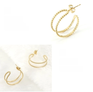 Detailed macro of 18K gold plated double hoop beaded earrings with polished finish