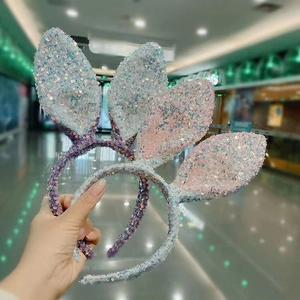Close-up of sequin bunny ear headbands in gradient blue, purple, and pink colors