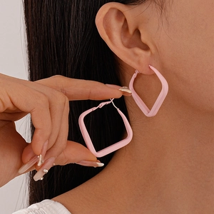 Close-up of pink square geometric hoop earrings with smooth matte finish for women