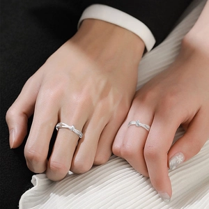 Elegant Mobius infinity knot couple rings in silver finish worn by a man and woman