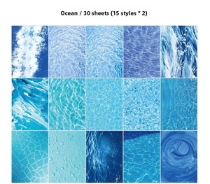 Macro view of ocean-themed scrapbook paper collection with 15 blue wave and bubble designs