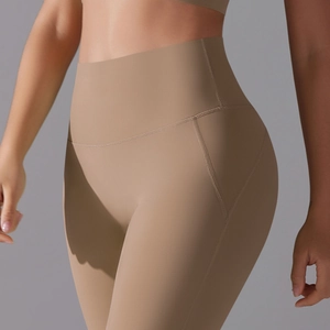 Detail view of high waisted khaki yoga leggings with seamless shaping and lifting effect