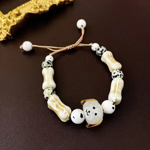 Ceramic puppy charm bracelet with bone beads and Dalmatian jasper stones on leather