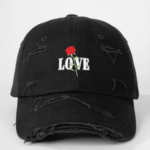 Detailed embroidery of white LOVE text and a red rose on a distressed black baseball cap