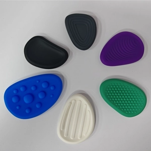 Close-up of six textured silicone sensory fidget stones in multiple colors and patterns