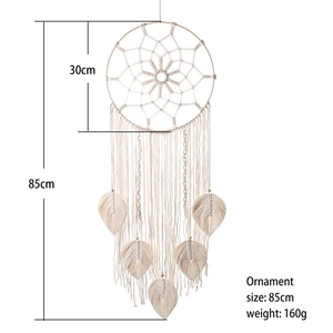 Beige handmade boho dream catcher wall hanging with leaf tassels and wood ring decor