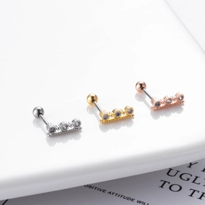 Macro shot of dragonfly crescent earrings in gold, silver, and rose gold with cubic zirconia