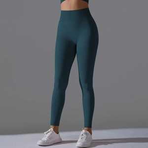 Detail view of seamless dark teal high-waisted yoga pants with wide tummy control waistband