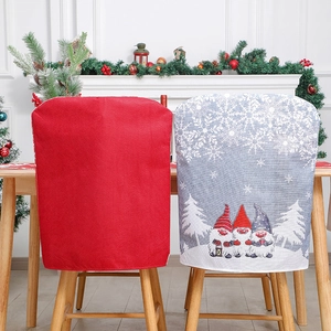 Christmas chair covers with red fabric and festive gnome patterns for holiday home decor