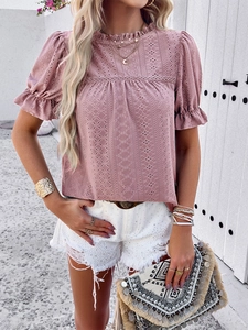 Detail of pink hollow out embroidery top with ruffle collar and puff short sleeves