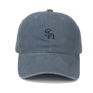 Detailed close-up of blue-grey cotton baseball cap with dark blue SH letter embroidery