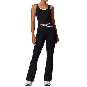 Women's black yoga set with high waisted flared pants and contrast trim crop top