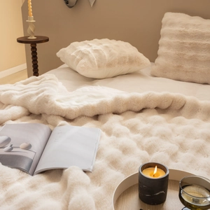 Close-up of luxury cream faux rabbit fur blanket with soft striped texture for sofas