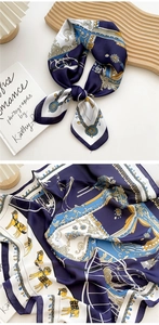 Close-up of silk scarf with equestrian horse print, nautical chains and baroque pattern