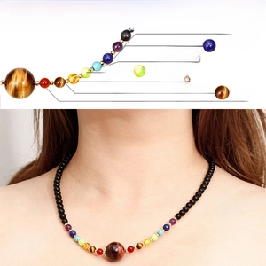 Detail of 7 chakra natural stones necklace showing healing crystal beads on a female model