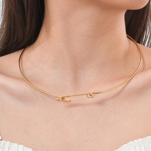 Detail of 18K gold stainless steel choker featuring a creative safety pin clasp design