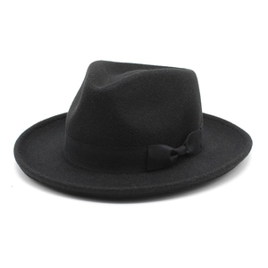 Detail of black wool fedora featuring a matching satin ribbon and elegant side bow