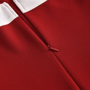 Detailed macro view of the seamless concealed zipper and red-white contrast fabric texture