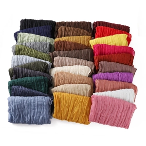 Breathable crinkle linen-cotton scarves in multiple colors neatly folded on white