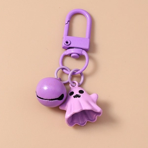 Detail of purple cartoon ghost keychain with matching bell and sturdy metal swivel hook