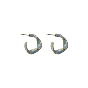 Elegant C-shaped earrings in light blue enamel with golden edges on white background