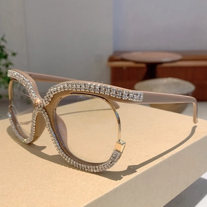 Detail of oversized khaki glasses frame with sparkling rhinestones on an elegant box