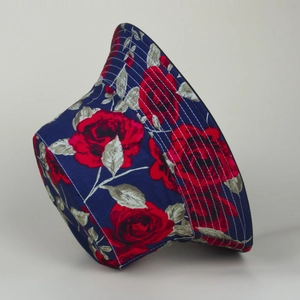 Detailed view of reversible bucket hat with red rose print on navy blue fabric