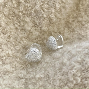 Macro shot of S925 sterling silver heart earrings with white cubic zirconia pavé setting