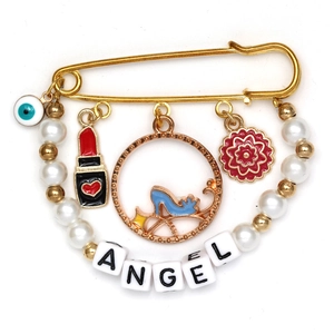 Detail view of gold brooch with evil eye, lipstick charms, and pearl angel lettering