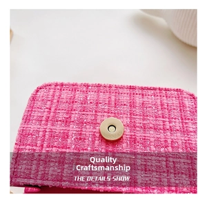 Detailed macro shot of pink tweed fabric and round metal magnetic clasp on kids' bag