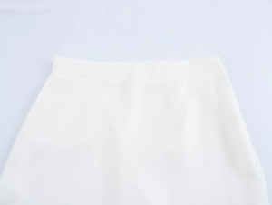 Close-up of the waistband on a white mermaid skirt featuring smooth fabric and fine stitching