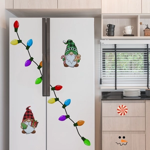 Macro shot of festive Christmas gnome magnets on a white refrigerator door
