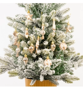 Detailed view of champagne gold Christmas tree ornaments with glitter and matte finishes
