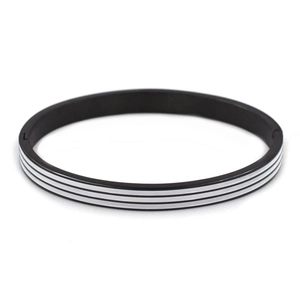 Detail of black titanium steel bangle featuring white triple stripes and a side hinge clasp