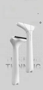 Macro view of 15 degree curved ergonomic handle and thinning metal teeth on a pet comb