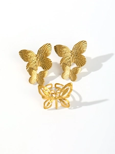 Detailed view of vintage gold butterfly jewelry set including stud earrings and ring