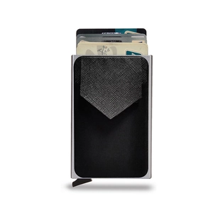 Macro shot of silver metal RFID card holder with pop-up cards and black textured surface